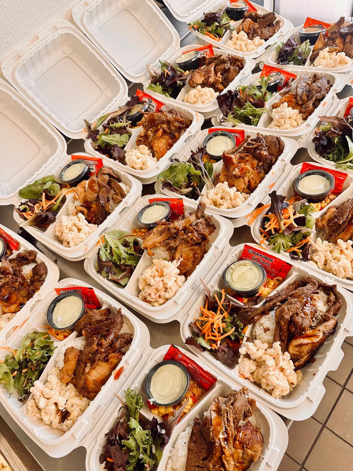 Mile High Luau catering trays with Korean short ribs, teriyaki chicken, sliced kalbi beef, macaroni salad and steamed rice